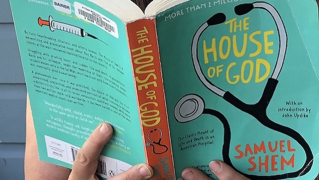 Woman reading the novel House of God.