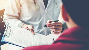 Doctor and patient discussing mental health form