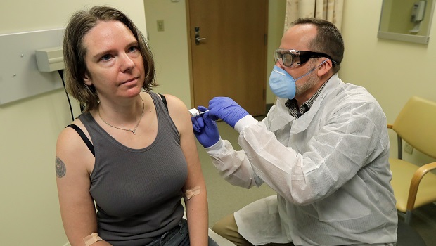 Jennifer Haller a clinical trial volunteer, receives the first-ever injection of an investigational vaccine for the coronavirus. Credit: Ted S. Warren / AP Photos